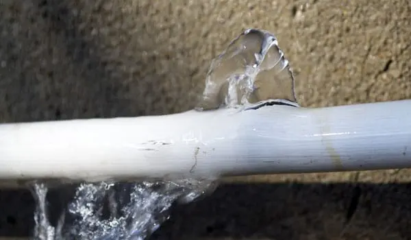 A burst water supply pipe spraying water in a Sun City, CA home