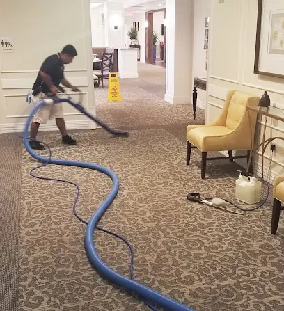 A technician extracting standing water from a floor in a Sun City, CA home